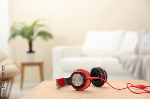 Stylish headphones on table indoors. Space for text