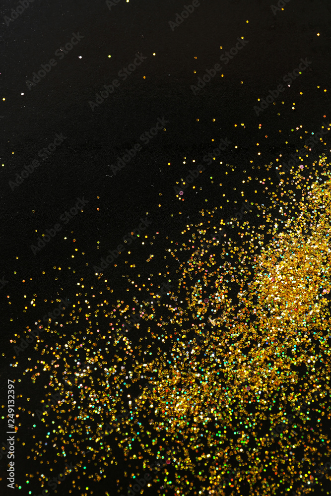 Gold glitter on black background, top view with space for text