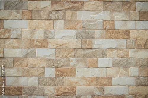 Featured stone tiles wall background texture. Clean and ordinary stone tile patterned.