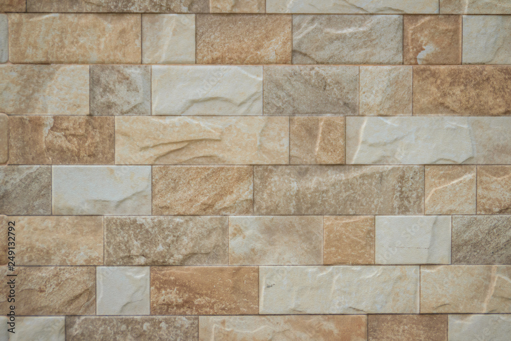 Obraz premium Featured stone tiles wall background texture. Clean and ordinary stone tile patterned.