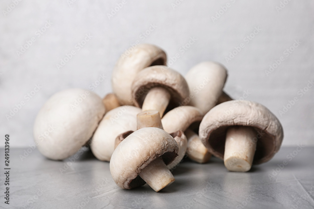 Pile of fresh champignon mushrooms on table, closeup Pile of fresh champignon mushrooms on table, closeup