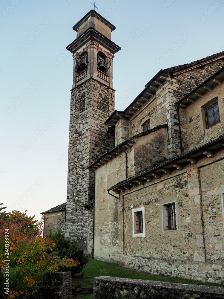 Piedmont - Italy: view of a stone bell tower of an old mountain church