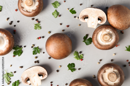 Flat lay composition with fresh champignon mushrooms on grey background
