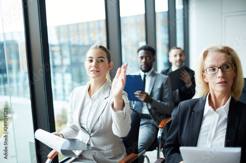 Quadro em tela One of confident delegates raising hand to ask or answer question at business se