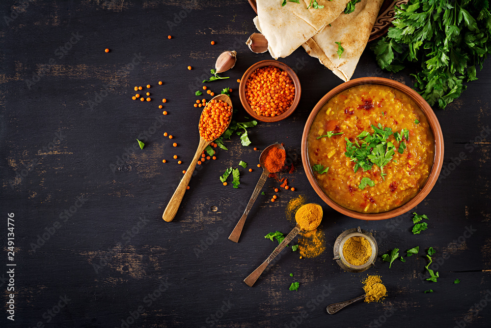 Indian dal. Food. Traditional Indian soup lentils.  Indian Dhal spicy curry in bowl, spices, herbs, rustic black wooden background. Top view. Authentic Indian dish. Overhead. Flat lay - obrazy, fototapety, plakaty 