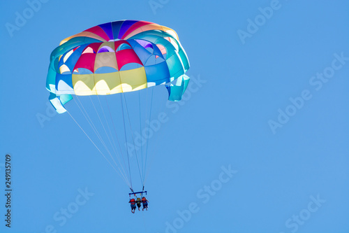 Fototapeta Naklejka Na Ścianę i Meble -  Sea and beach sport for tourists, parasailing in blue sky