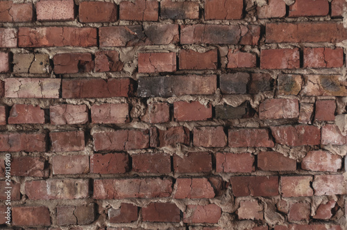 old bare brick wall with red bricks close up