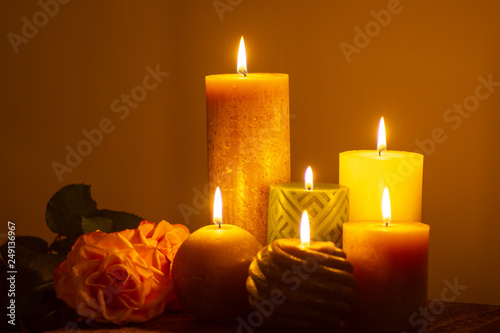 Six burning candles and roses, warm colors, feelings and memory, soft warm colors close up