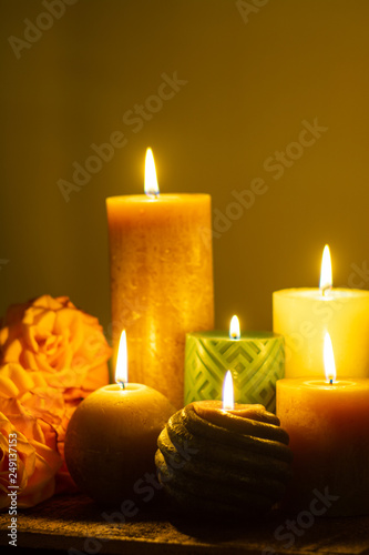 Six burning candles and roses, warm colors, feelings and memory, soft warm colors close up