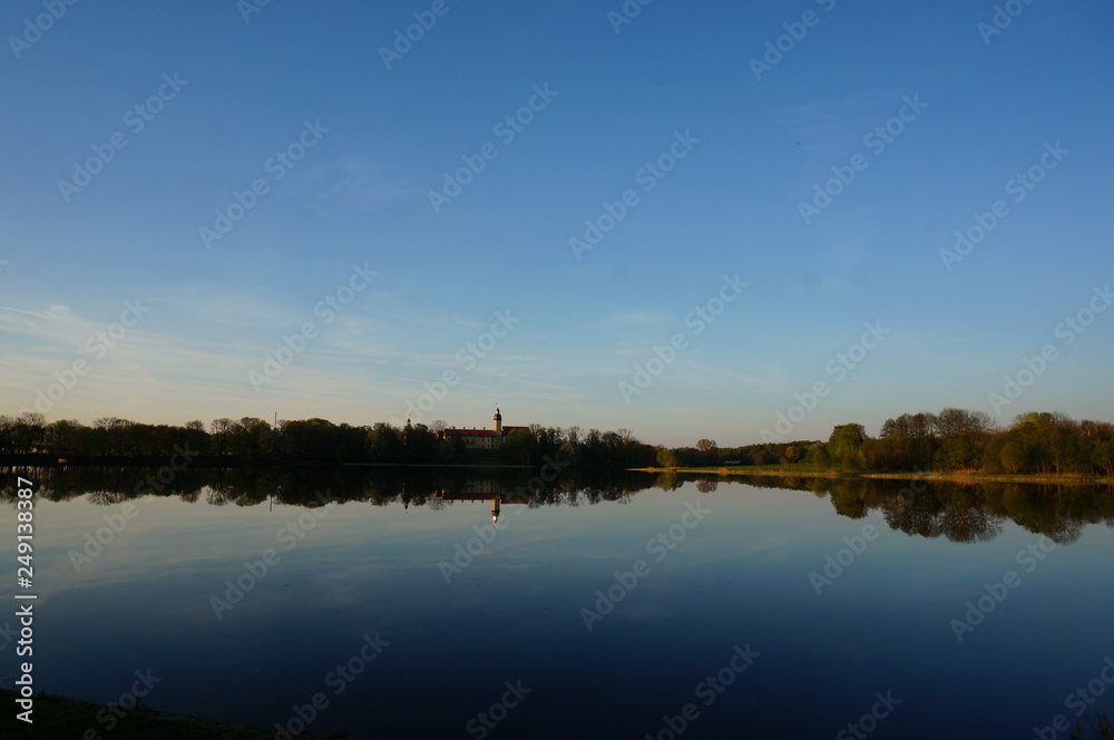 Reflection of Nesvizh Castle in the pond in autumn. Nyasvizh, Nieśwież, Nesvizh, Niasvizh, Nesvyzhius, Nieświeżh, in Minsk Region, Belarus. Site of residential castle of the Radziwill family. 