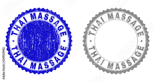 Grunge THAI MASSAGE stamps isolated on a white background. Rosette seals with grunge texture in blue and grey colors. Vector rubber stamp imitation of THAI MASSAGE caption inside round rosette.