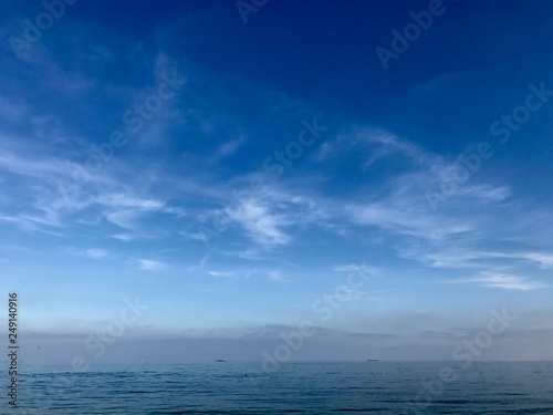 blue sky above the sea with clouds and sun in Greece