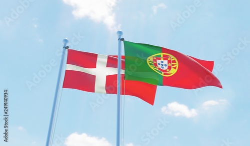 Portugal and Denmark, two flags waving against blue sky. 3d image