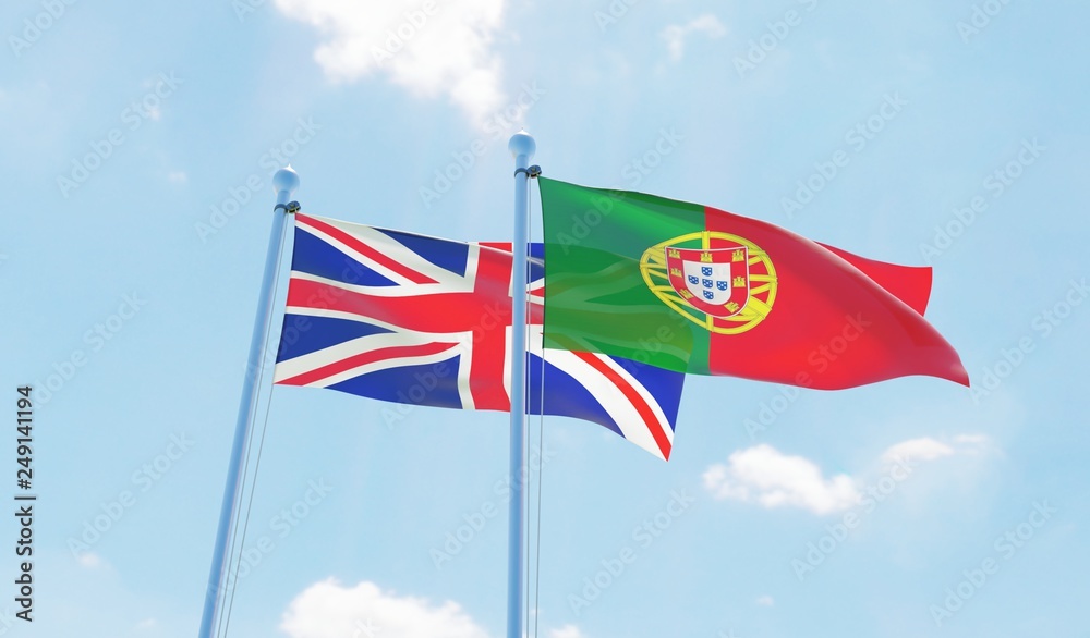 Portugal and UK, two flags waving against blue sky. 3d image