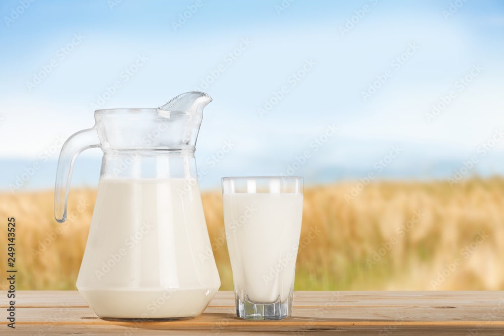 Glass jug of fresh milk on background Glass jug of fresh milk on background