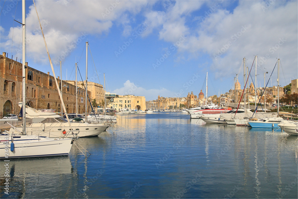 Malta island harbor with moored yachts and boats.