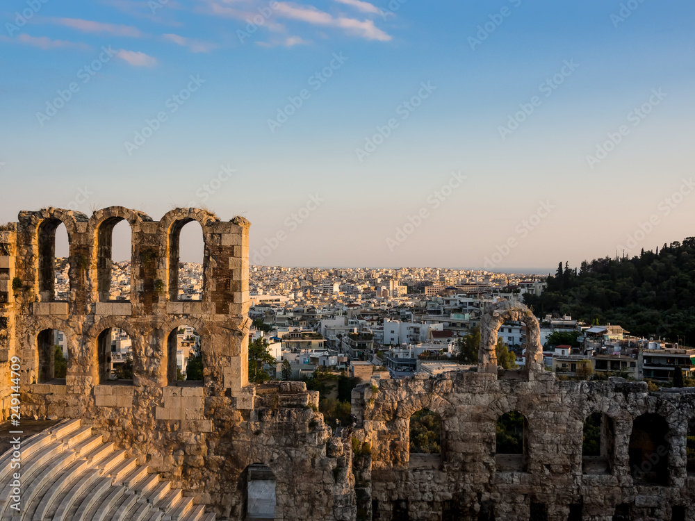 Odeon of Herodes Atticus arches and rows of seats of southern slope of Acropolis in Athens, Greece in soft light of a summer sunset