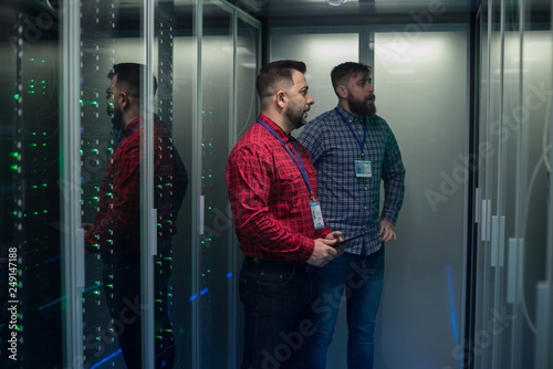 Coworking adult men diagnosing server hardware