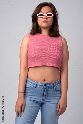 Portrait of young beautiful Asian woman with novelty glasses