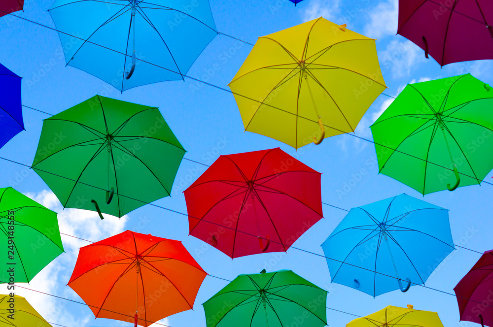 colorful umbrellas, white, blue, green, red and yellow against the background of the summer sky, umbrellas of different colors from the sun colorful umbrellas, white, blue, green, red and yellow against the background of the summer sky, umbrellas of different colors from the sun