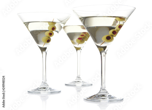 Three classic dry martini with olives isolated on white background