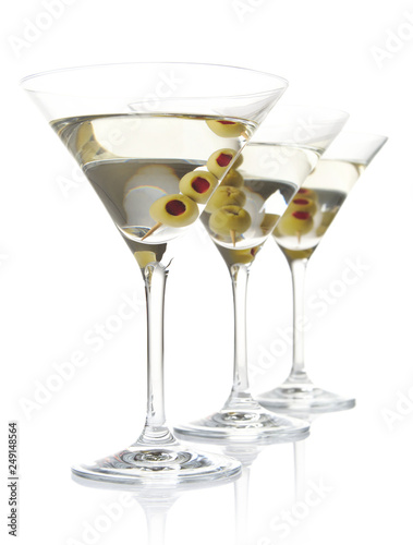 Three classic dry martini with olives isolated on white backgrou