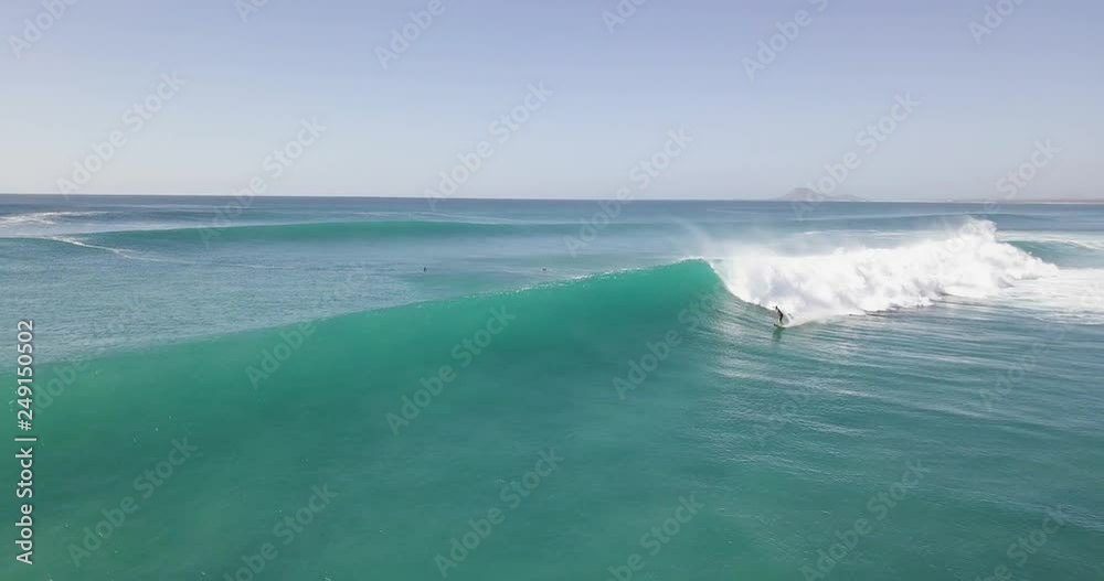Aerial Drone video of a surfer riding a big wave on the island of Sal in Cape Verde.