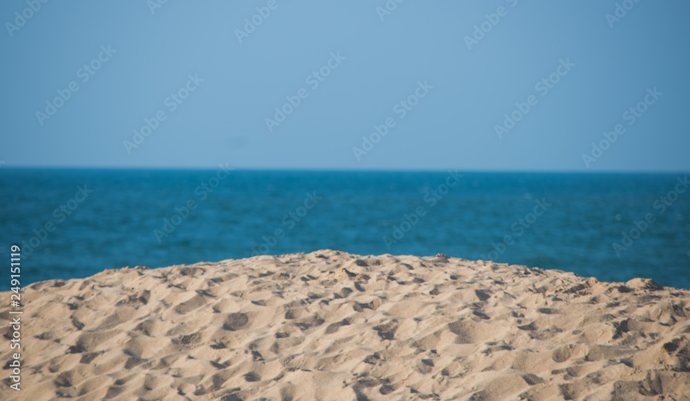 Beach Scene With Sand Blue Water And Blue Sky
