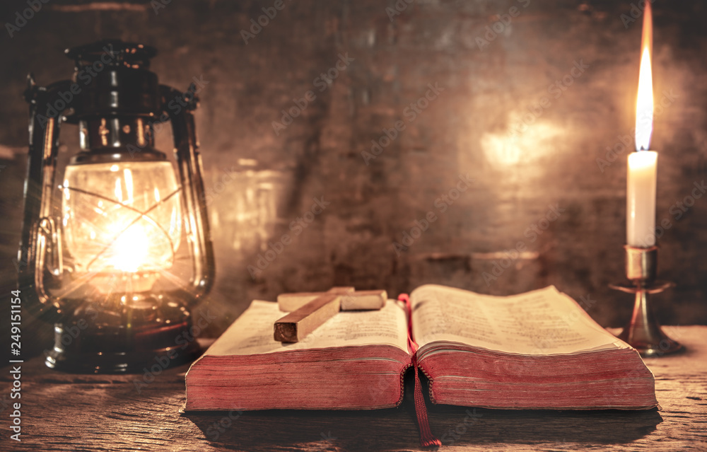 Holy bible with light candle and on wooden table. christian concept. Stock Photo | Adobe