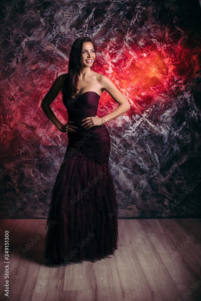 gorgeous sexy woman in evening dress posing over dark background gorgeous sexy woman in evening dress posing over dark background