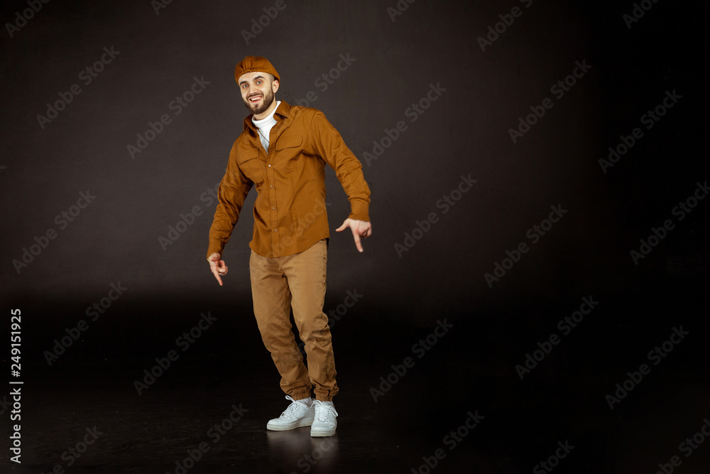 Young handsome man possing and modeling wearing beige clothes Young handsome man possing and modeling wearing beige clothes