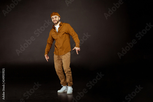 Young handsome man possing and modeling wearing beige clothes