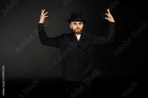 Portrait of a young man with beard wearing black hat