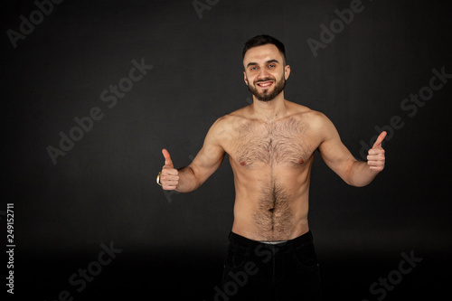 Amazing male model with beard smiling and raises fingers