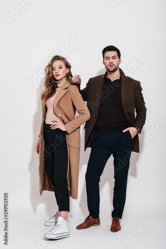 Looking amazing. Attractive and well-dressed couple posing in studio. photo