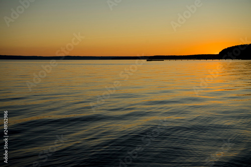 Orange sunset over the river or lake