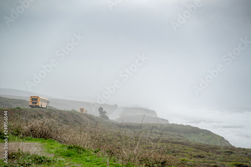 Yellow School Bus drives down Pacific Coast Highway around Santa Cruz California photo