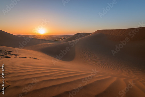 Sunset in the desert with beautiful sand dunes.
