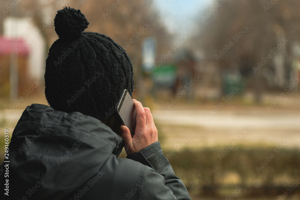 Mobile phone conversation on street in winter