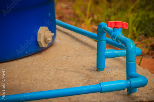 Red knob of PVC ball valve on the PVC pipe line in plumbing system for control the water to storage tank.