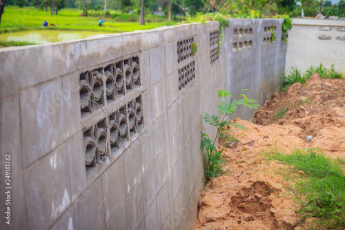 Fence wall of the newly built housing is tilted and collapsed due to high earthwork and heavy rainfall, causing the soil in the house to weaken and flow out with the water although there are drains.