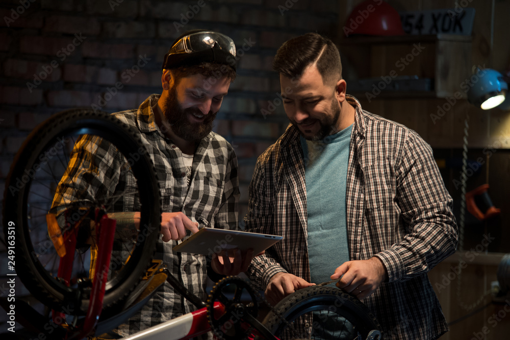 Two mechanic talking in a workshop