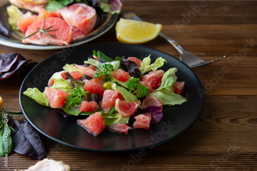 Salad with grapefruit, lose weigh food. Diet plan. Wooden rustic table.