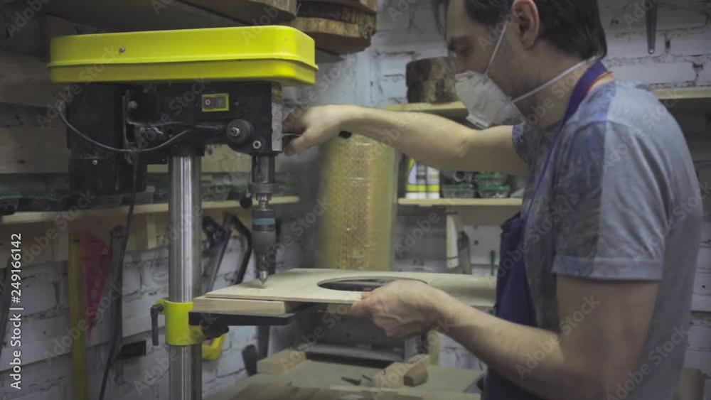 Man is craft working at a work bench with power tools Man is craft working at a work bench with power tools