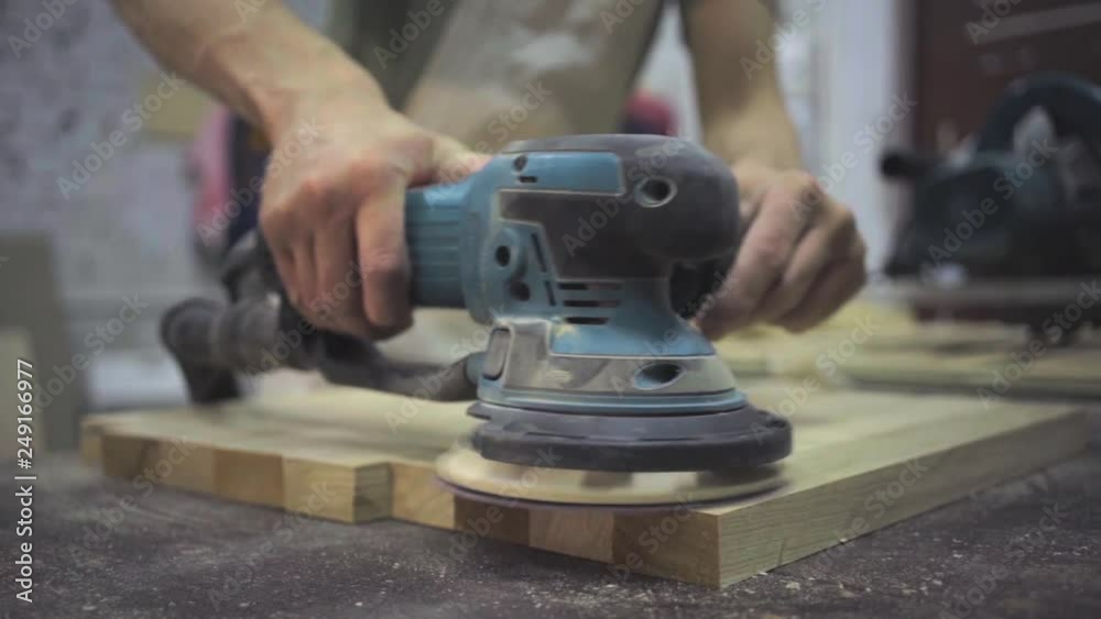 Man is craft working at a work bench with power tools
