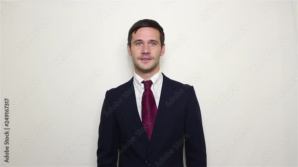 Young beautiful businessman in blue suit smiling and waving her hand greeting customers.Portrait on a white background. Young beautiful businessman in blue suit smiling and waving her hand greeting customers.Portrait on a white background.