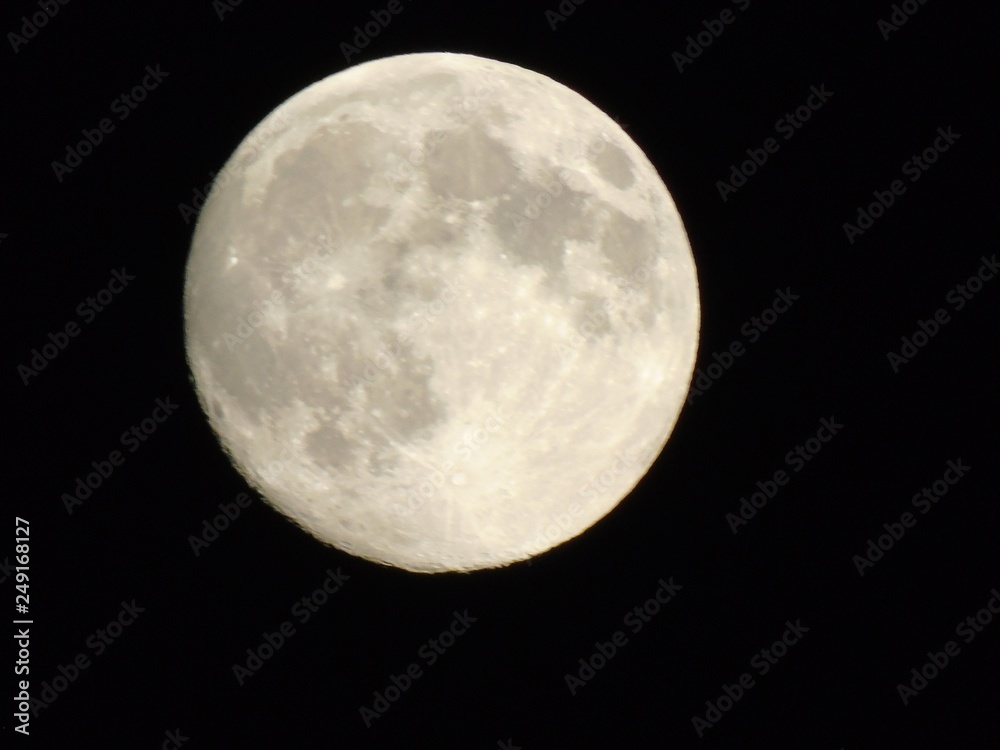 Genova, Italy - 10/24/2018: An amazing photography of the full moon over the city of Genova by night with a great clear sky in background and some stars using high zoom. Genova, Italy - 10/24/2018: An amazing photography of the full moon over the city of Genova by night with a great clear sky in background and some stars using high zoom.