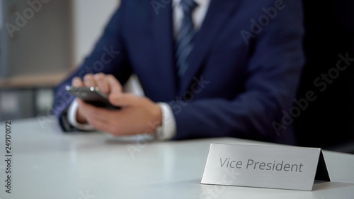 Obraz na plátně Company vice president using smartphone for communication, viewing files online
