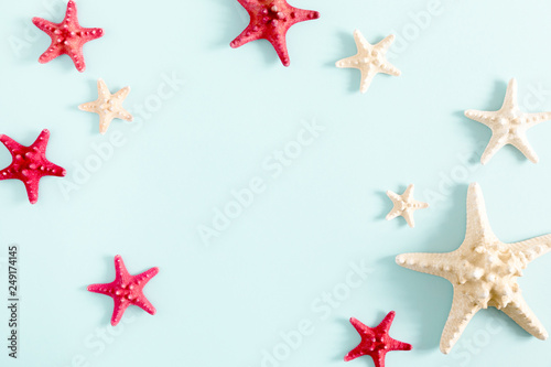 Summer minimal composition. Creative layout made of starfish on pastel blue background. Summer creative concept. Flat lay, top view, copy space