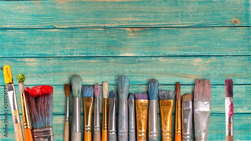 Row of artist paint brushes on desk